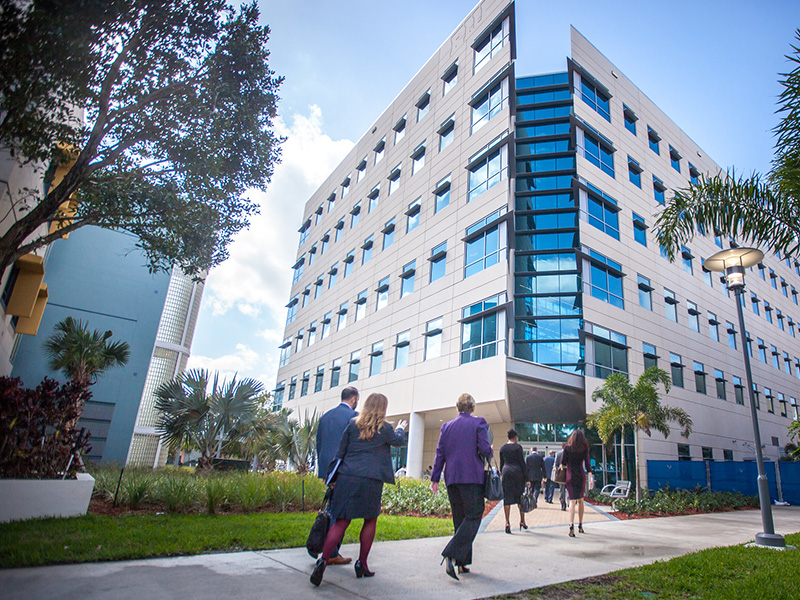 People walking towards the FIU College of Business Complex