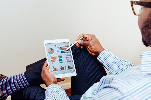 Man reading charts on a tablet