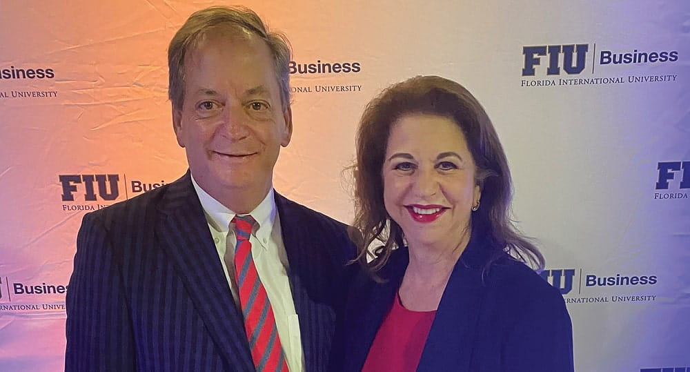 William Hardin, interim dean, FIU Business, and Yolanda Nader, CEO and CFO, Dosal Tobacco, at a Dec. 10 holiday reception for members of the FIU Business Dean's Council and advisory boards.