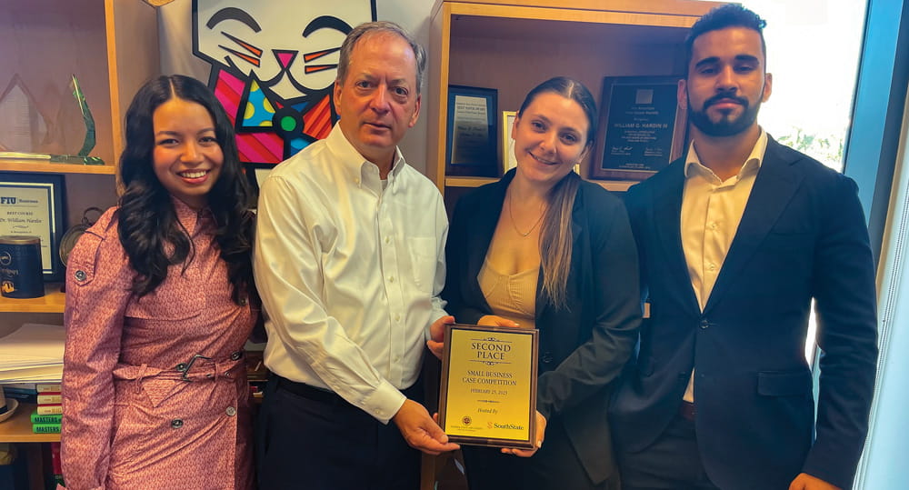 (L to R) FIU Business student Andrea Visso; William Hardin, dean, FIU Business; and students Alexis Peck and Aymane Bahaj with the second-place award the finance undergraduates won at the SouthState Bank case competition on February 25, 2023.