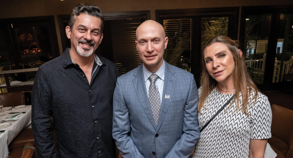 (L to R) Eddie Leon (MSIRE ’22), CEO and coowner, M.I.A. Beer Company; Eli Beracha, director, Hollo School of Real Estate at FIU Business; and Anna Castaño, at the REact 2022 VIP Dinner held on November 3, 2022, the night before the conference.