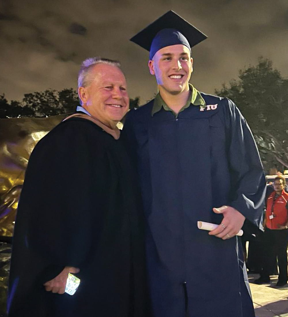 (L to R) Rafael Soltero, associate teaching professor, marketing, FIU Business and undergraduate business graduate Angel Otero at the fall commencement ceremony on December 10, 2023.