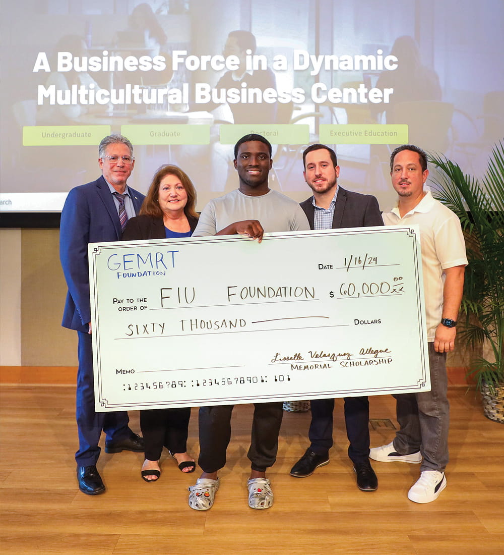 Accounting major Travis Lindor (center), who received the GEMRT Lissette Velasquez Allegue Memorial First Generation Scholar scholarship, with partners from the Garcia, Espinosa, Miyares, Rodriguez, Trueba & Co. accounting firm, which gifted $60,000 to FIU Business, at a check presentation on November 16, 2023.