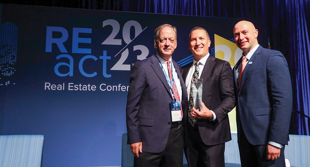 (L to R) William Hardin, dean, FIU Business; Lifetime Achievement Award recipient Malcolm Butters (MSIRE '83), president, Butters Construction & Development; and Eli Beracha, director, Hollo School of Real Estate, at the REact 2023 real estate conference hosted by the Hollo School of Real Estate at FIU Business on November 3, 2023.