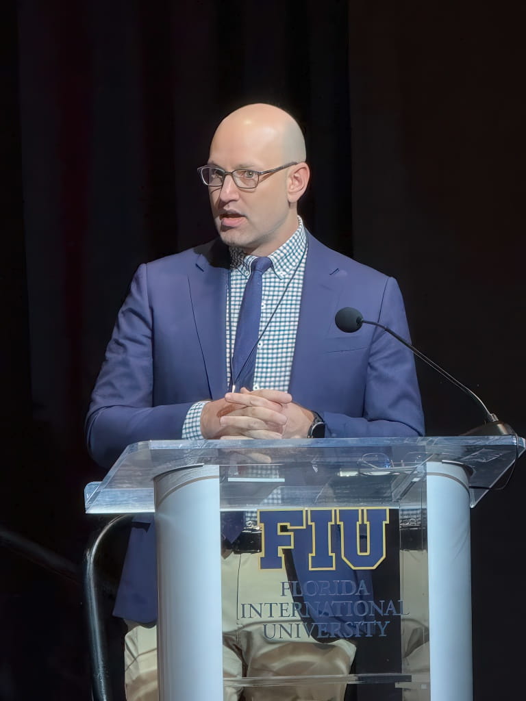 Mark Thibodeau, professor at the Hollo School of Real Estate, gives welcome remarks at the 2026 CCIM Miami Commercial Real Estate Outlook Conference, held at the Graham Center on January 14, 2026.