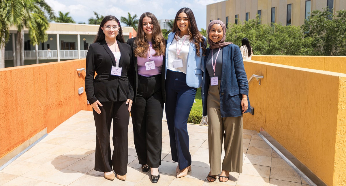 Students Mira Urra, Michelle Kim Heinze, Natalie Martinez and Raisa Ali, winners of the 2025 hackathon-style challenge that caps off the ATOM Pink Tank leadership program, held April 11.