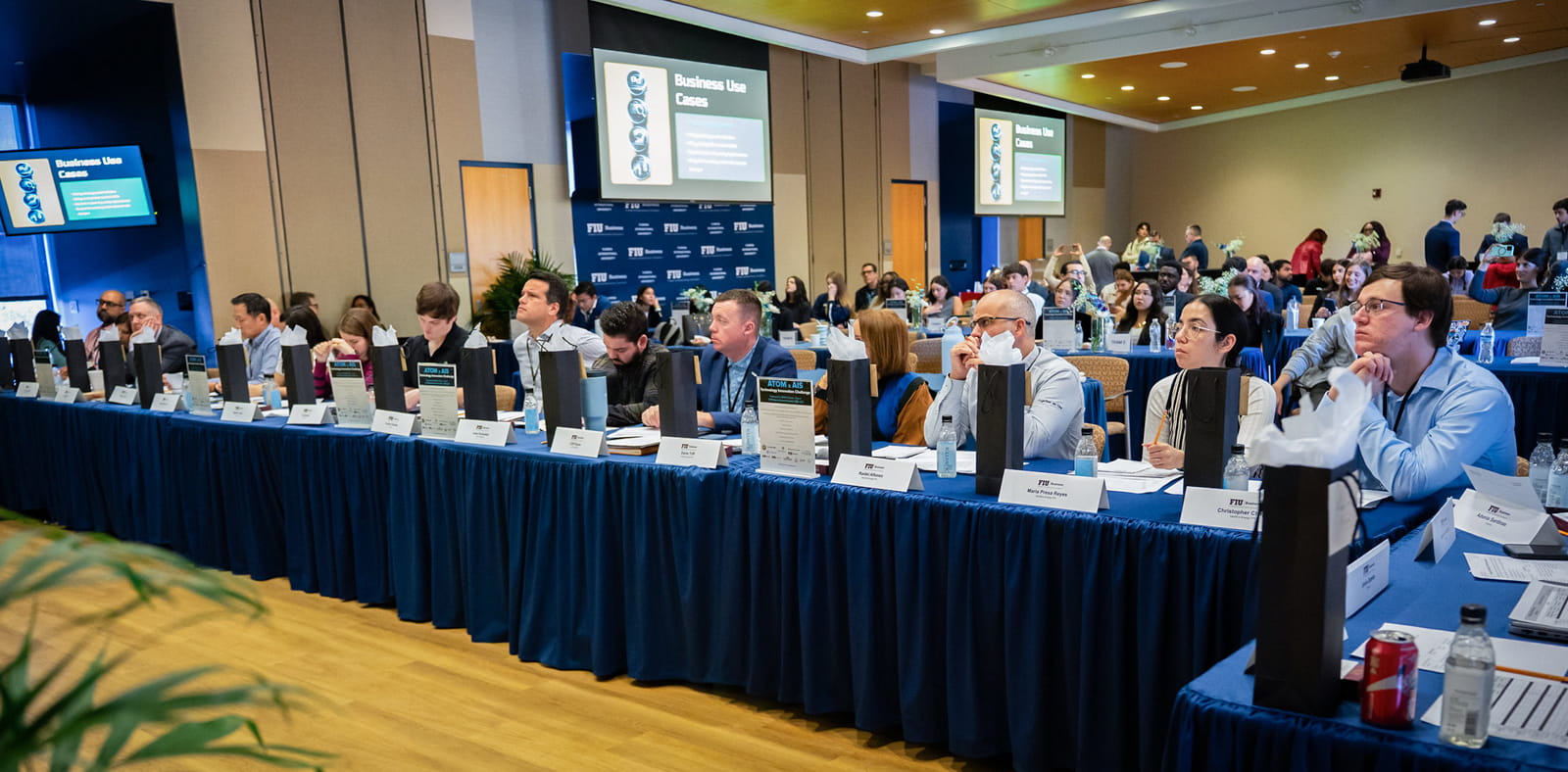 A panel of industry experts listen to student presentations