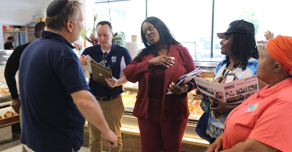 City of North Miami Beach Commissioners Daniela Jean and Paule Villard meeting with a North Miami Beach business owner