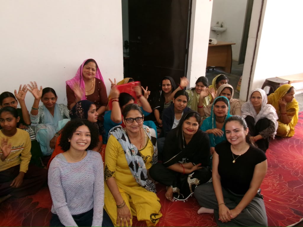 FIU students sitting with the women artisans of the Bandhwari Women’s Project