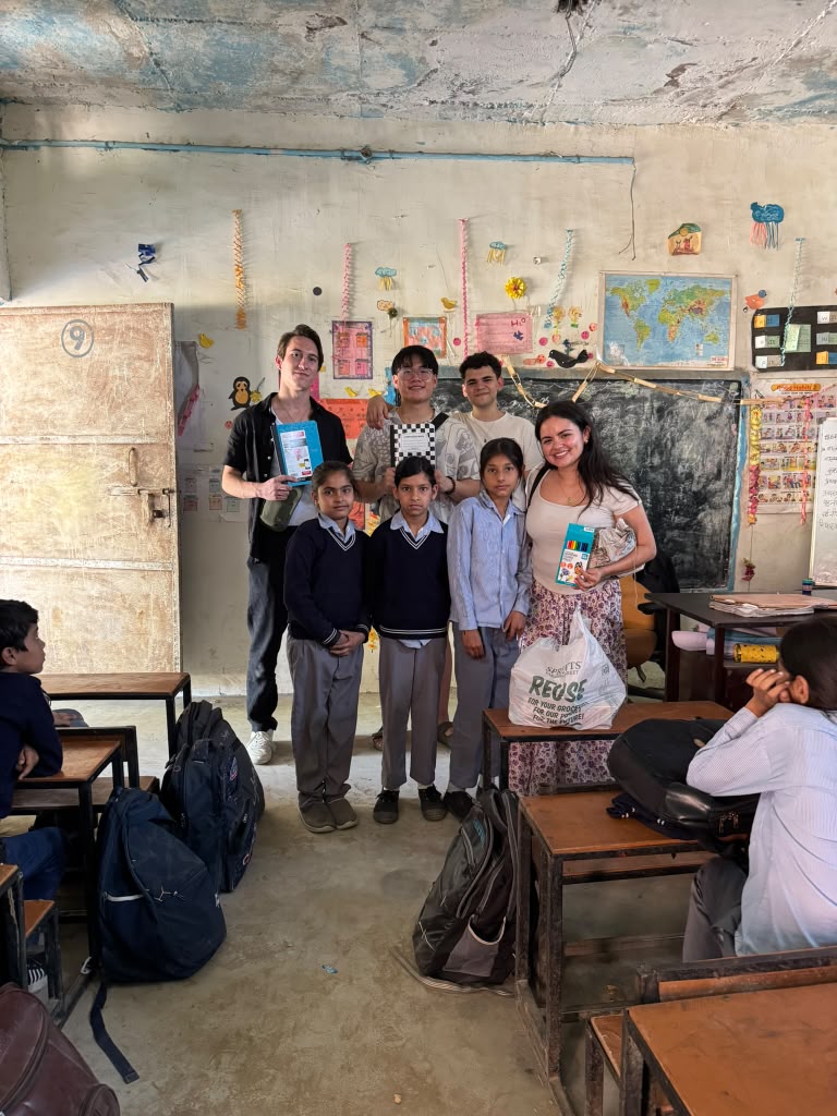 FIU students sharing school supplies with children in a classroom in India